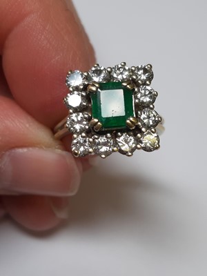 Lot 71 - An emerald and diamond square cluster ring.