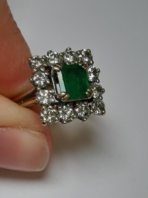 Lot 71 - An emerald and diamond square cluster ring.