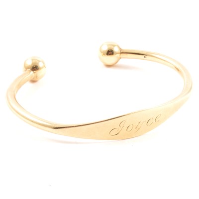 Lot 180 - A 9 carat yellow gold torque bangle.