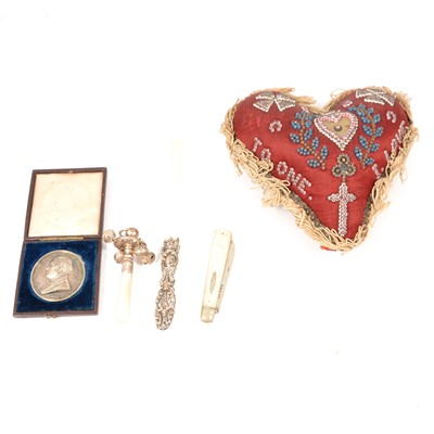 Lot 275 - A heart shaped beaded pin cushion, Royal Horicultural Society medal, baby's rattle and other silver.