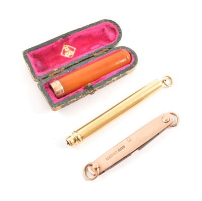 Lot 287 - A gold retractable pencil, penknife and amber cheroot holder.