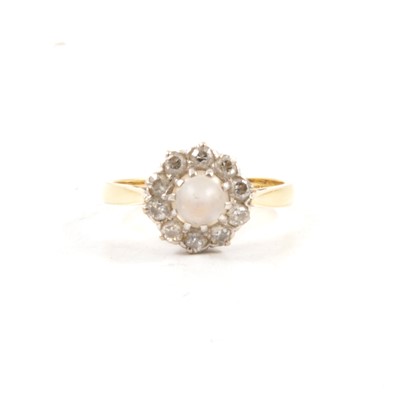 Lot 29 - A moonstone and diamond cluster ring.