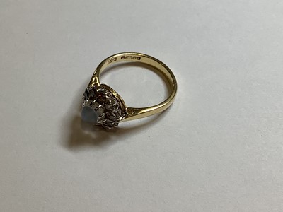 Lot 29 - A moonstone and diamond cluster ring.
