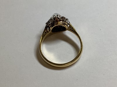 Lot 29 - A moonstone and diamond cluster ring.