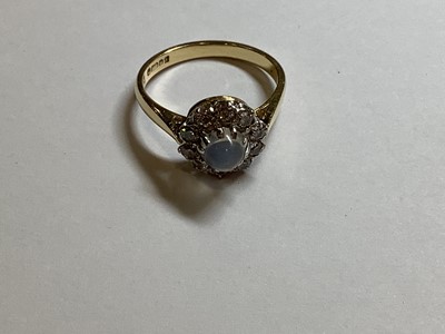 Lot 29 - A moonstone and diamond cluster ring.