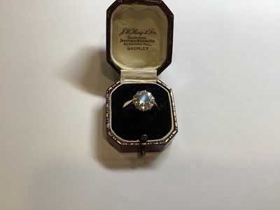 Lot 29 - A moonstone and diamond cluster ring.