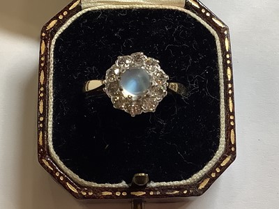 Lot 29 - A moonstone and diamond cluster ring.