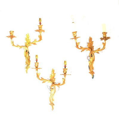 Lot 154 - Set of three gilt metal twin-branch wall lights