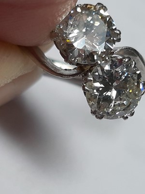 Lot 12 - A diamond two stone crossover ring.