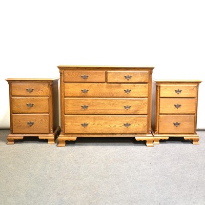 Lot 700 - Oak chest of drawers and two matching bedside sets of drawers