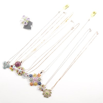 Lot 259 - Nine gemset floral pendants on white metal chains.