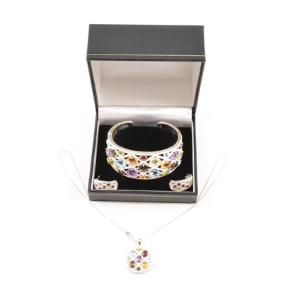 Lot 410 - A multi gem pendant, earrings and hinged bangle suite.