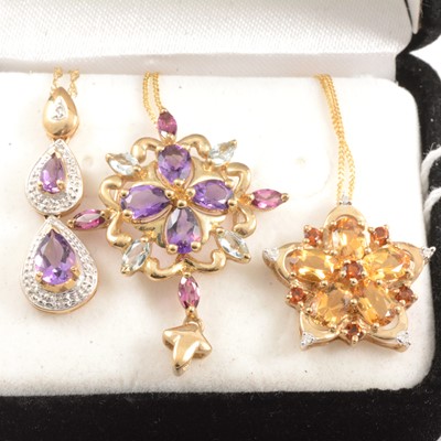 Lot 257 - Three gemset pendants with 9 carat yellow gold and yellow metal chains.