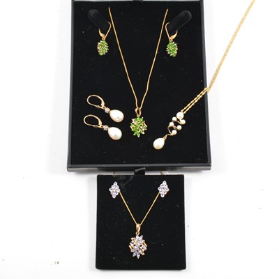 Lot 391 - Three necklace and earrings suites.