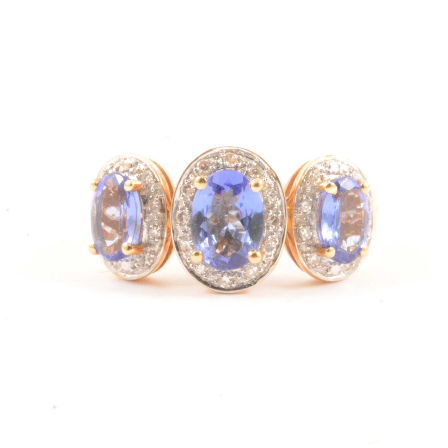 Lot 62 - A tanzanite and diamond cluster ring.