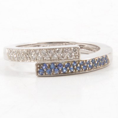 Lot 46 - A sapphire and diamond crossover ring.