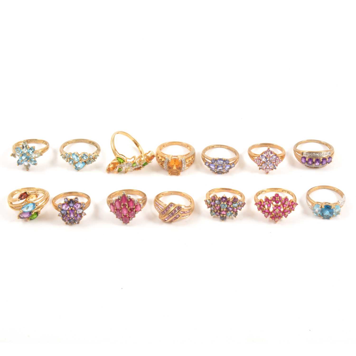 Lot 123 - Eighteen modern gemset 9 carat gold rings.