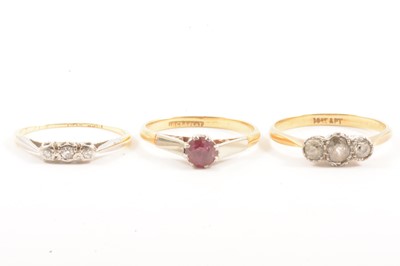 Lot 112 - Two vintage diamond three stone rings and a ruby solitaire ring.