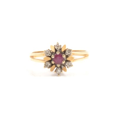 Lot 67 - A ruby and diamond cluster ring.