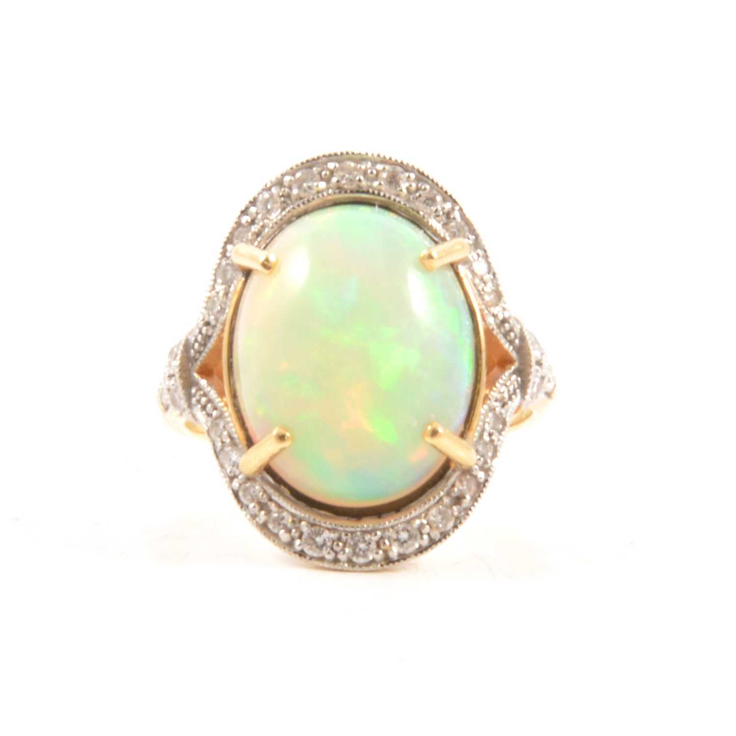 Lot 76 - An opal and diamond cluster ring.