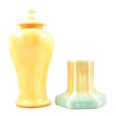 Lot 37 - Ruskin Pottery - a yellow glaze lidded jar and two tone candlestick.