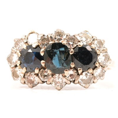 Lot 212 - A sapphire and diamond triple cluster ring.