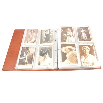 Lot 189 - An album of approximately 324 photo and printed images, greetings cards