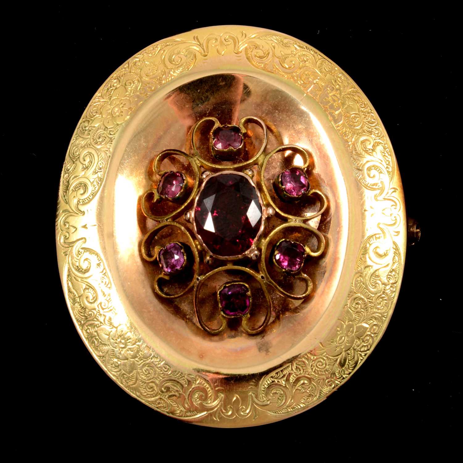 Lot 126 - An yellow metal brooch set with garnet coloured stones.