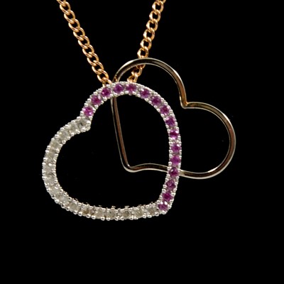 Lot 88 - A pink stone and diamond heart shaped pendant and chain.