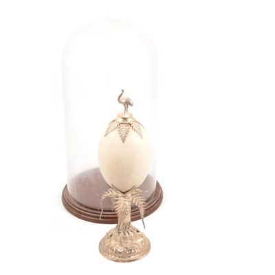 Lot 104 - An Emu egg with white mounts under a glass dome.