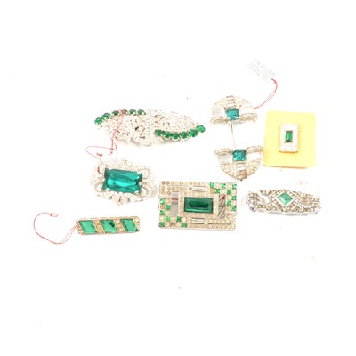 Lot 278 - Six faux emerald brooches and a duette dress clip.