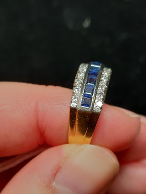 Lot 19 - A sapphire and diamond half hoop ring.