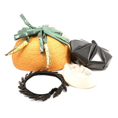 Lot 328 - Simone Mirman - a black vinyl 1960's beret, an un-named straw "Banana" hat, feathers.