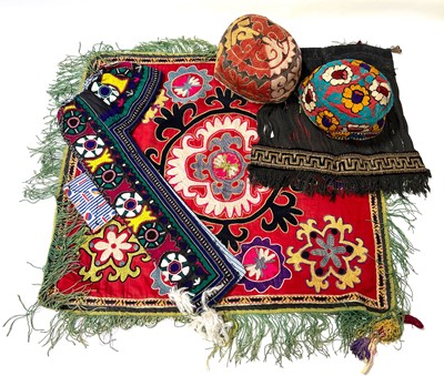 Lot 2 - Quantity of Uzbekistan textiles, hats, and a Bridal Viel
