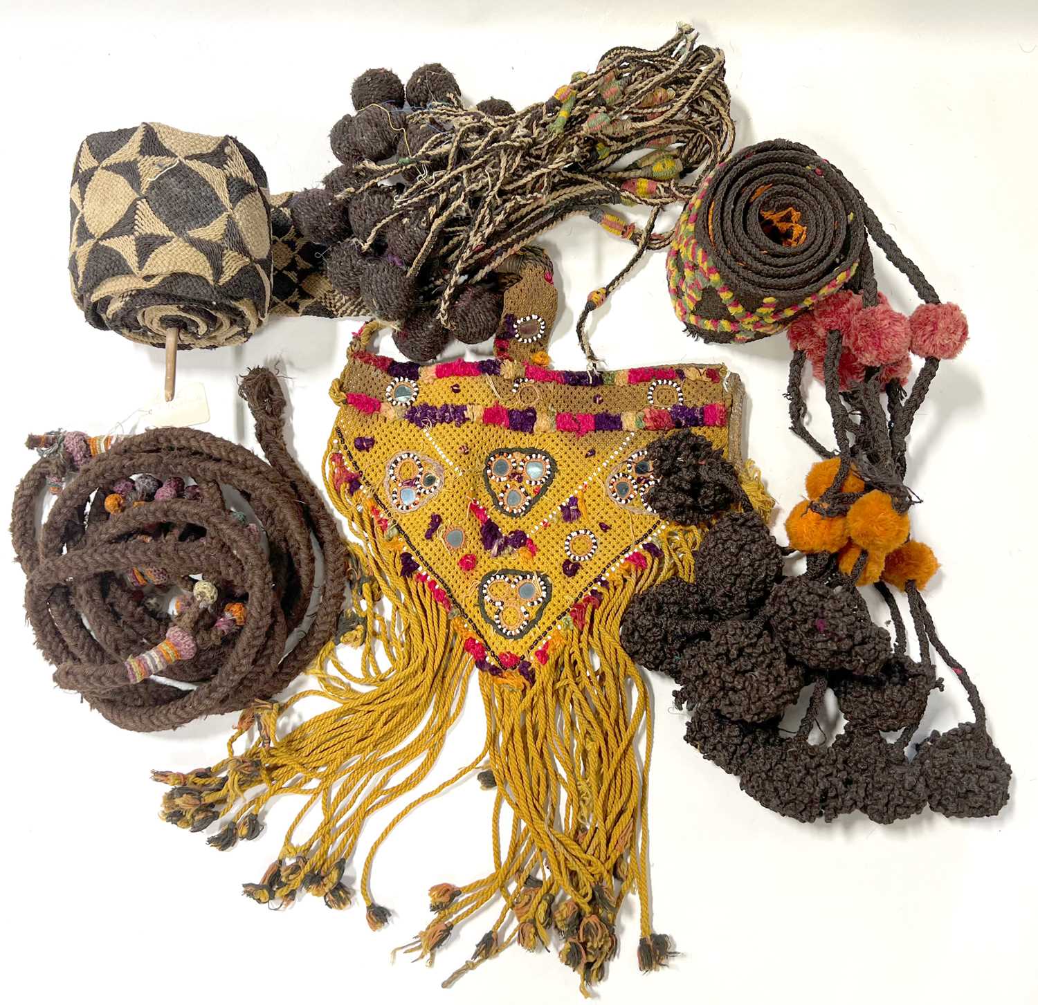 Lot 14 - Quantity of woven camel girths, and animal decorations