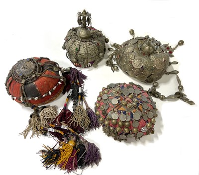 Lot 25 - Four Afghan hats, metal adornments