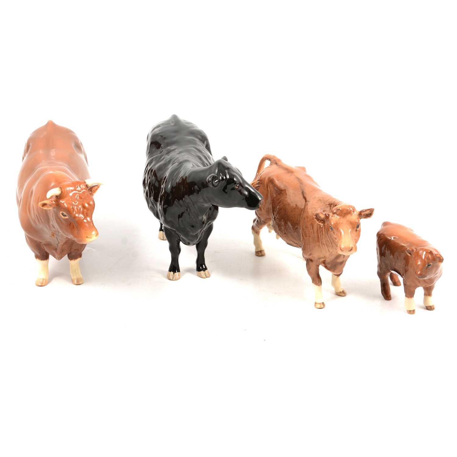 Lot 140 - Four Beswick pottery cattle models,