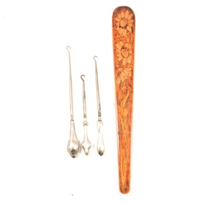 Lot 244 - Wooden page turner and three silver handled button hooks.