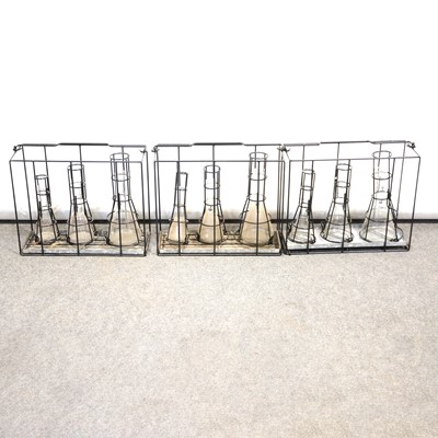 Lot 196 - Three set of three glass measuring flasks, 1L, 500ml, 250ml, each in a metal carry-frame.