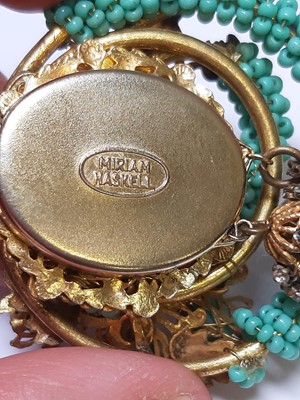 Lot 383 - Miriam Haskell - a signed faux turquoise, paste and gilt metal necklace and bracelet suite.