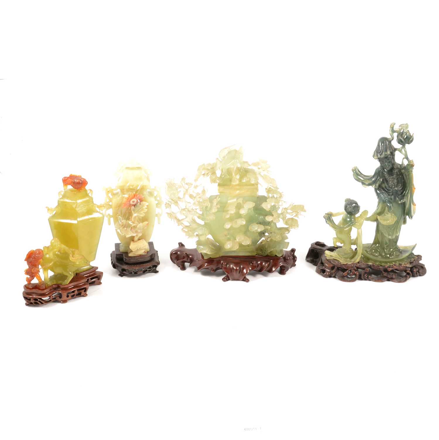 Lot 82 - Four modern carved green jade pieces on wooden bases.