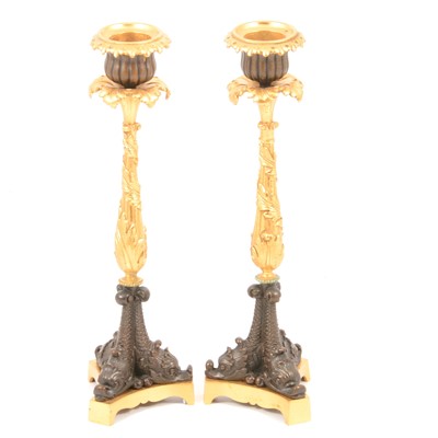 Lot 141 - Pair of bronze and parcel gilt candlesticks