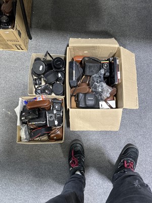 Lot 129 - Three boxes of vintage cameras and lenses.