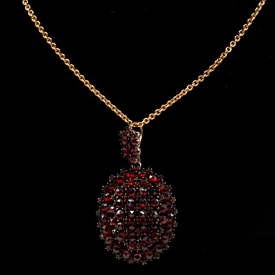 Lot 196 - An oval gemset pendant and chain.