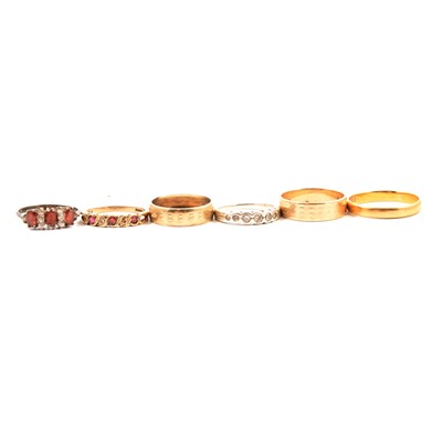 Lot 295 - A 22 carat yellow gold wedding band, two 9 carat yellow gold wedding bands, and three other rings.
