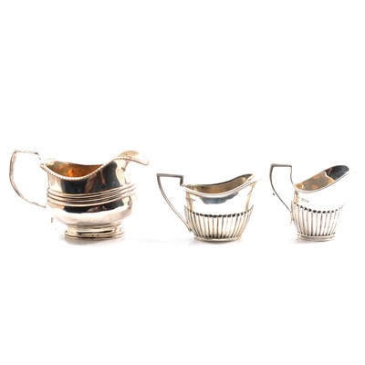 Lot 261 - A George III silver milk jug,  and two silver cream jugs
