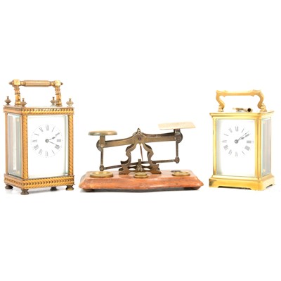 Lot 110 - Two brass cased carriage clocks and a set of postal scales