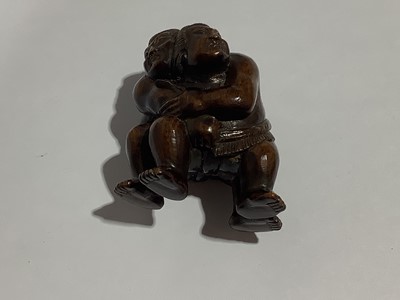 Lot 141 - Collection of eleven carved wooden netsukes and a tagua nut netsuke