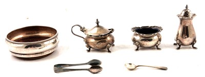 Lot 280 - Silver bottle coaster, three piece condiment set, plated sugar tongs.