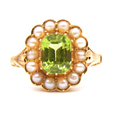 Lot 56 - A peridot and pearl cluster ring.